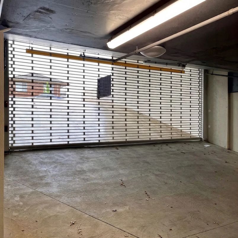 Commercial roller grille door in an underground car park