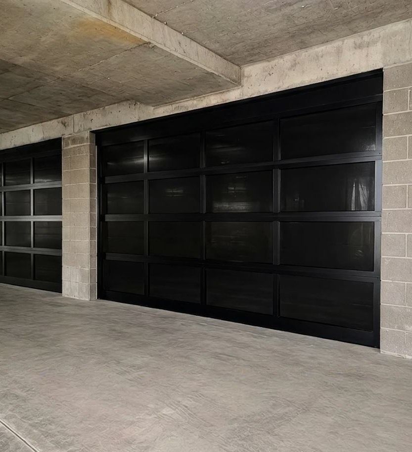 Black glass panel garage doors in an apartment car park